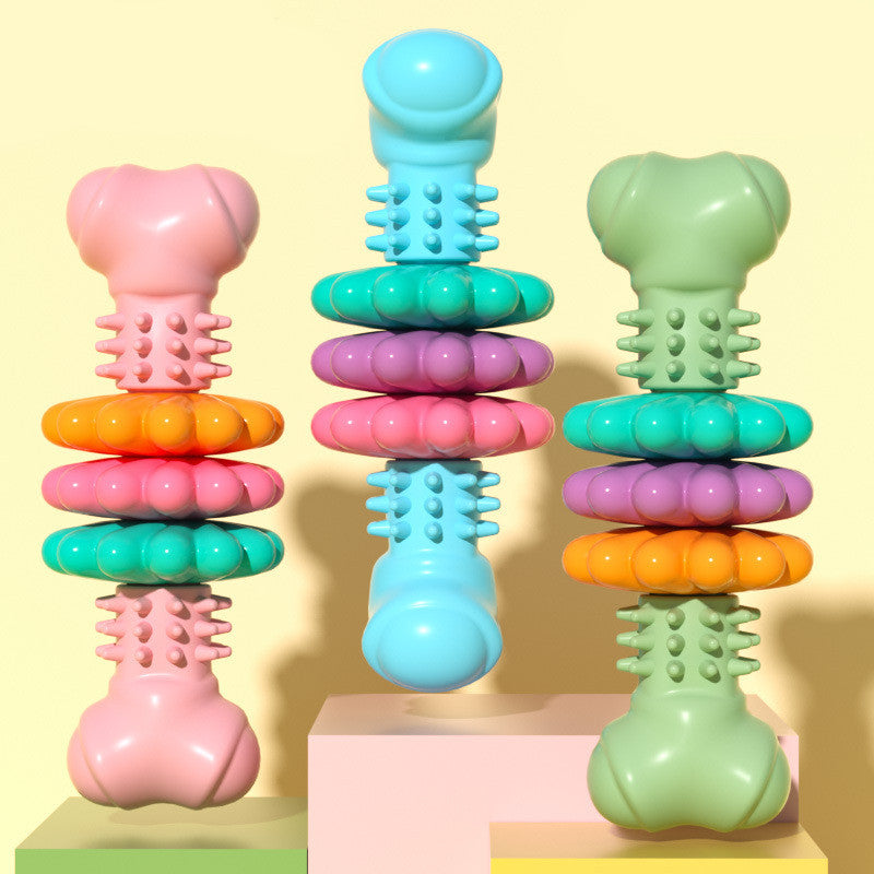 Colorful stackable toy with various shapes and textures on a yellow background