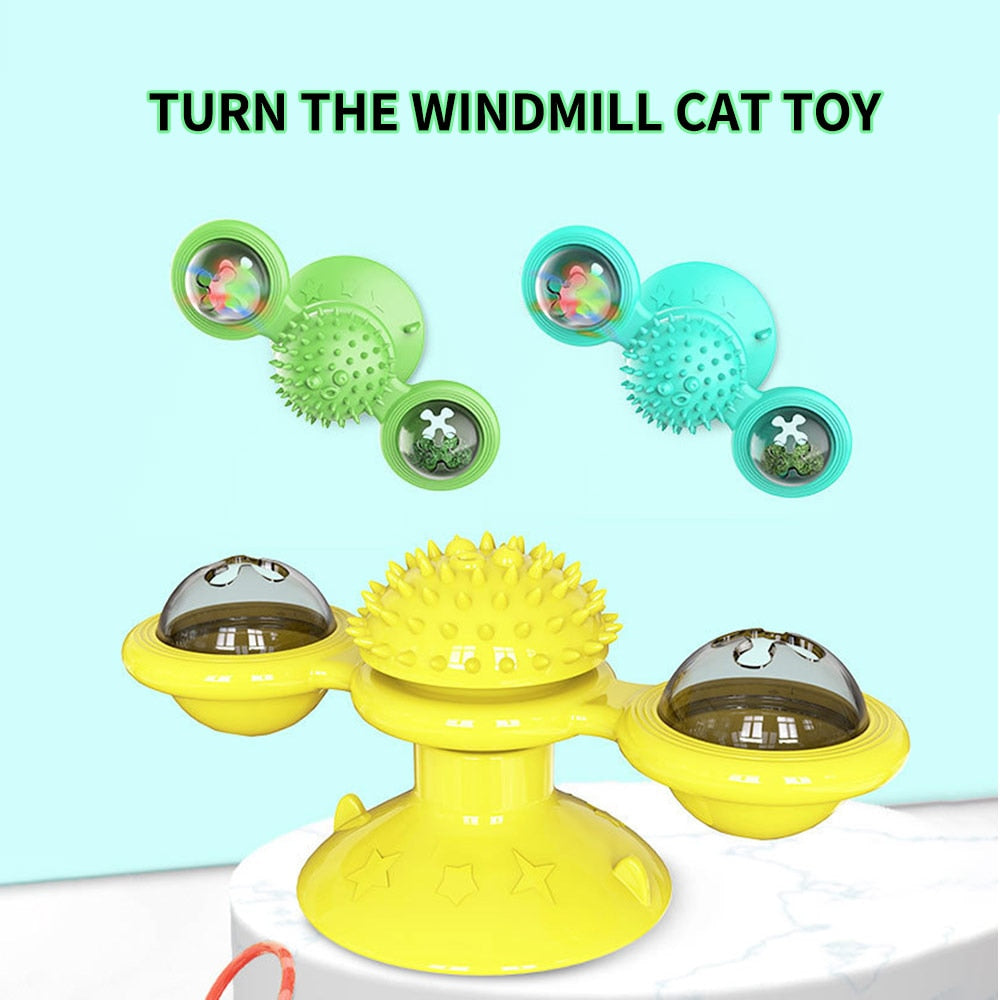 Yellow windmill cat toy with green and blue components on a light blue background