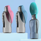 Three water bottles with colorful caps on a light blue background
