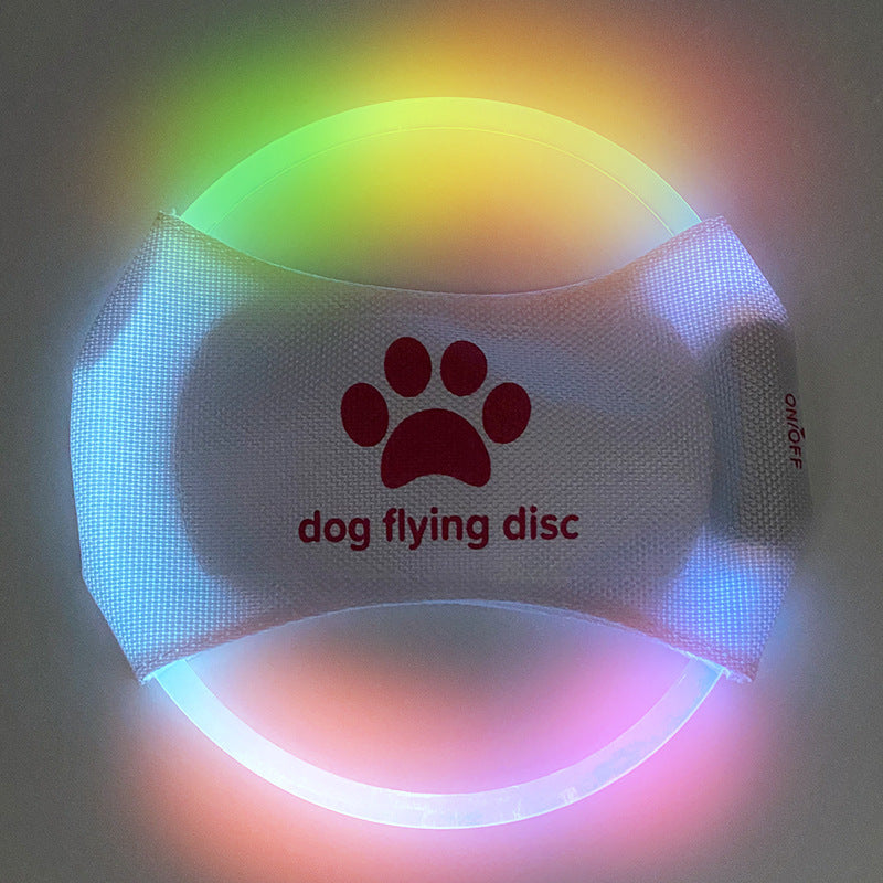 Colorful LED dog flying disc with a paw print logo on a dark background